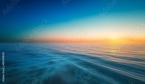 A sunset over the ocean with a boat and the ocean in the background