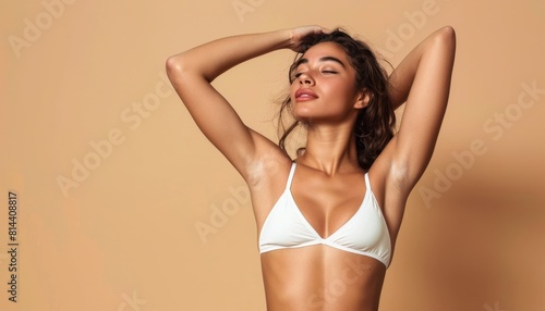 Elegant Woman Posing in White Bikini Top. © MOMO