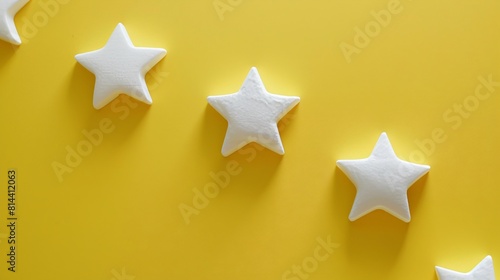 Three-dimensional white stars on a yellow background.