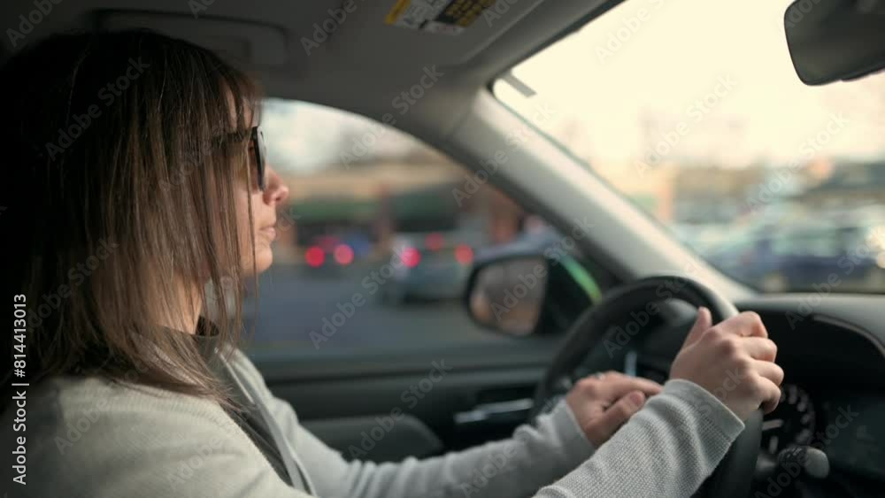 A focused woman drives her car through city traffic, captured from the passenger perspective, highlighting urban commuting in a modern lifestyle setting. A focused woman drives her car through city traffic, captured from the passenger perspective, highlighting urban commuting in a modern lifestyle setting.