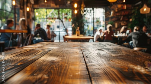 wood table with blur of people in cafe or restaurant on background © Amer