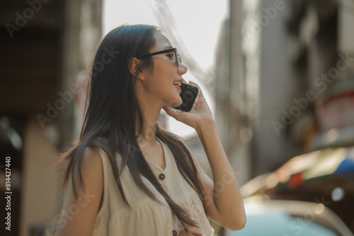 a beautiful Asian woman is walking around street food market in day time, lovely teenager is smiling and feeling happy on her holiday,  traveler gorgeous woman extremely enjoy on her vacation