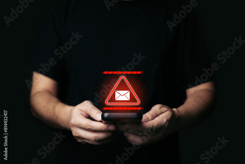 Man Holding smartphone with alert Email inbox and spam virus with warning caution for notification on internet letter security protect, junk and trash mail and compromised information.