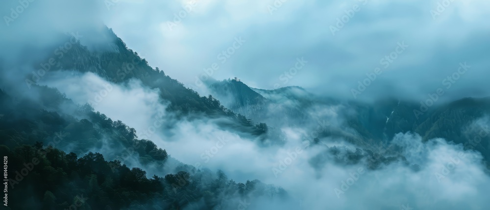 Obraz premium Fog rolling over a mountain pass, creating a mysterious and obscured backdrop for moody themes,