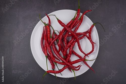 top view of red chili peppers in white plate