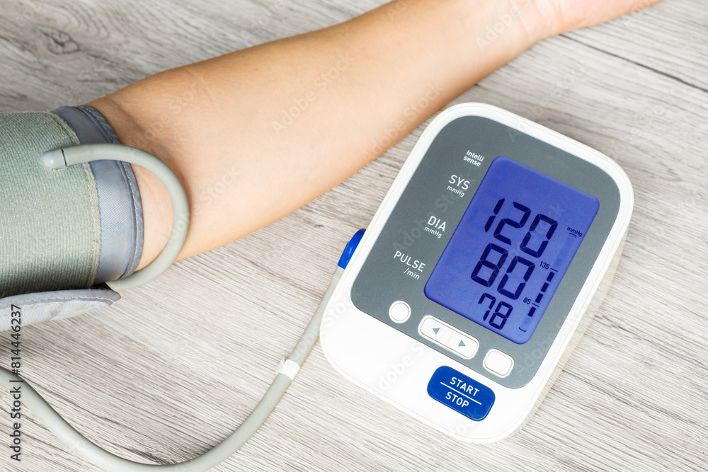 Man check blood pressure monitor and heart rate monitor with digital pressure gauge. Health care and Medical concept Man check blood pressure monitor and heart rate monitor with digital pressure gauge. Health care and Medical concept