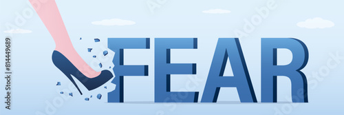 Female shoe kicking hard the giant FEAR word. Overcoming fear and scare concept. Overcome mental and psychological problems. Freedom, equality.
