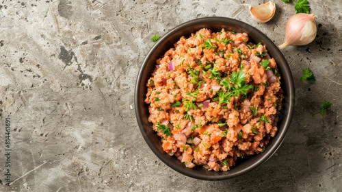 Close-up top view of ground pork in a bowl, highlighted with garlic, onion, and herbs, focusing on its preparation for pork burgers, studio lighting, isolated background
