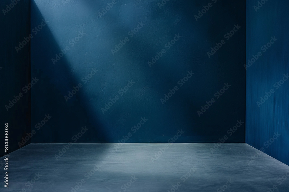 A minimalist dark blue studio backdrop with a smooth gradient, complemented by a neutral grey floor, offering ample copy space for design or text A minimalist dark blue studio backdrop with a smooth gradient, complemented by a neutral grey floor, offering ample copy space for design or text