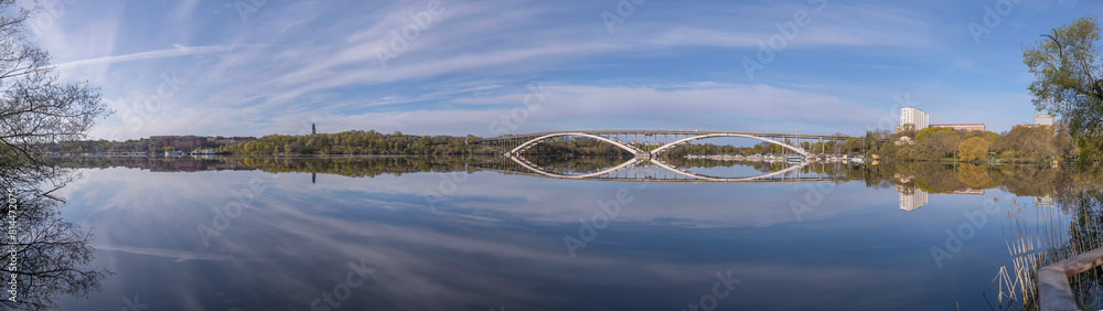 Panorama view at the calm bay Riddarfjärden, the long bridge Västerbron in the district Kungsholmen, a sunny summer morning in Stockholm Panorama view at the calm bay Riddarfjärden, the long bridge Västerbron in the district Kungsholmen, a sunny summer morning in Stockholm