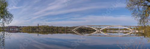 Panorama view at the calm bay Riddarfjärden, the long bridge Västerbron in the district Kungsholmen, a sunny summer morning in Stockholm
