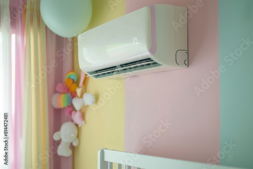 A modern, energy-efficient air conditioner mounted on a pastel-colored wall in a cozy baby bedroom, ensuring optimal climate control for a comfortable and safe kids room environment   photo