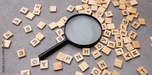 Magnifying glass with many wood letters of English alphabets, learning English concept