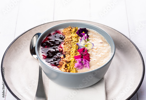 A healthy bowl of porridge with berries and muesli for a colourful fresh breakfast