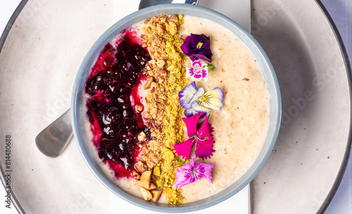 A healthy bowl of porridge with berries and muesli for a colourful fresh breakfast
