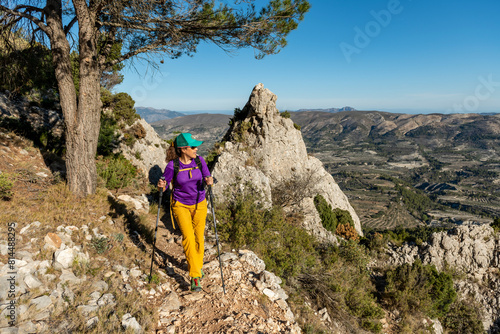 A woman hiking in the mountains, Serrella peak, Quatretondeta, Alicante, Spain - stock photo