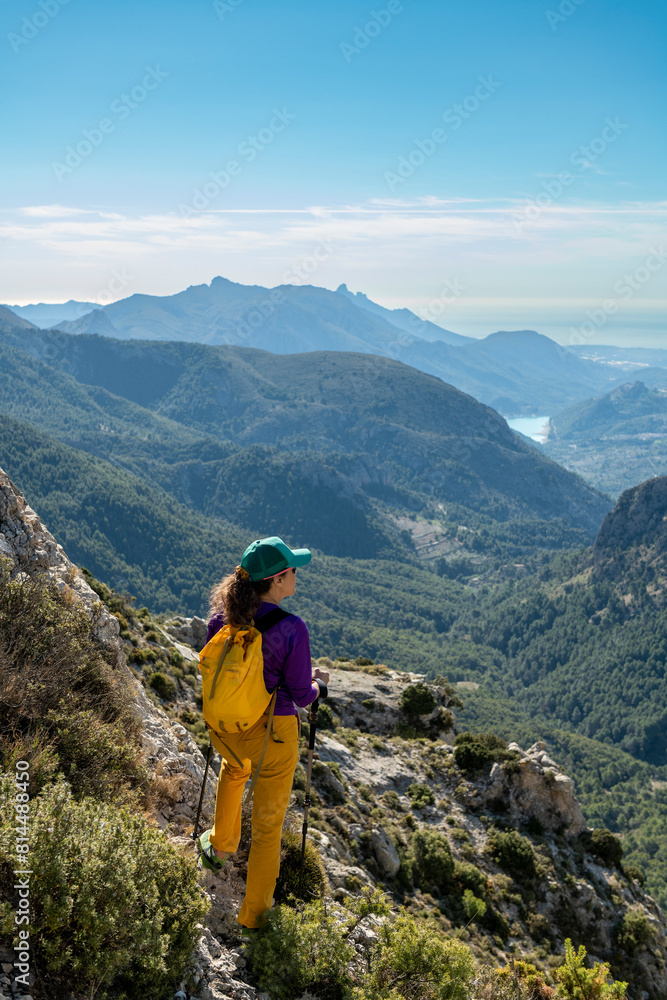 A woman hiking in the mountains, Serrella peak Quatretondeta, Alicante, Spain - stock photo