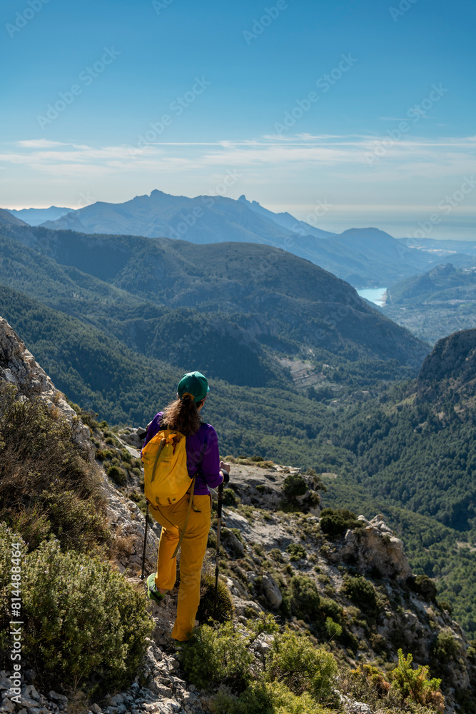Fototapeta premium A woman hiking in the mountains, Serrella peak Quatretondeta, Alicante, Spain - stock photo