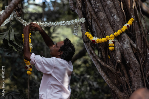  man helps to hang decorations before the wedding ceremony 