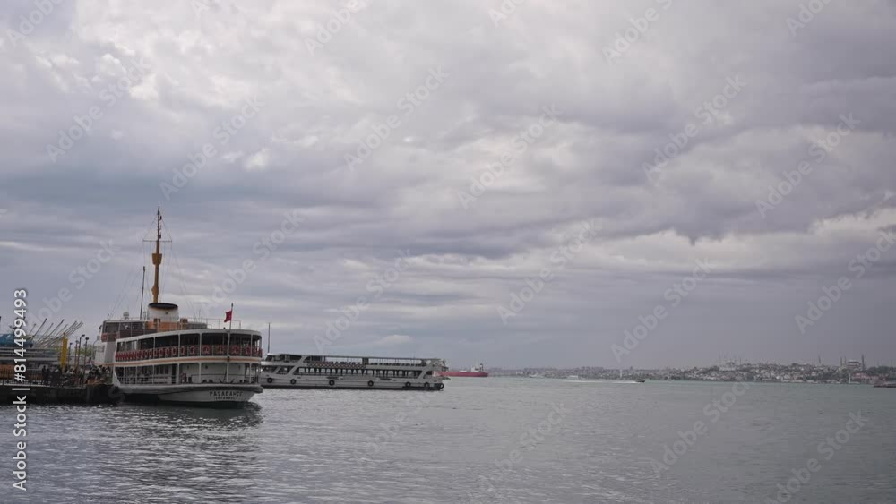 At the Kadıköy pier, in cloudy weather, ships are sailing, birds are flying, on the Bosphorus. At the Kadıköy pier, in cloudy weather, ships are sailing, birds are flying, on the Bosphorus.
