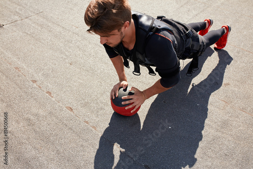 awesome sportsman is doing exercises with a ball. full length photo.top view photo.