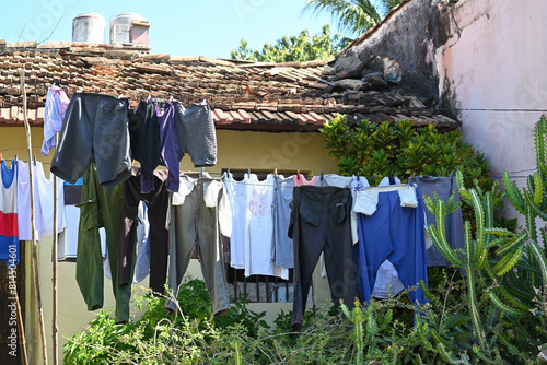 Laundry is dried on a rope in the backyard of the house
