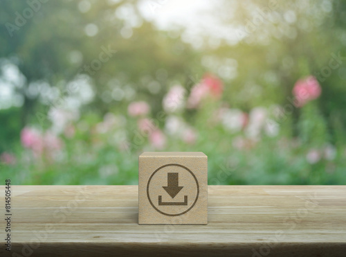 Download icon on wood block cube on wooden table over blur pink flower and tree in park, Technology internet online concept