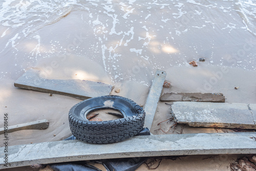 Car tires with garbage is abandoned in beach 