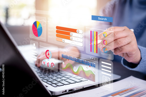 Businessman using a laptop with Analytics and Data Management Systems Analyst working in Business Analytics and Data Management Systems to make reports and corporate strategy for finance, operations