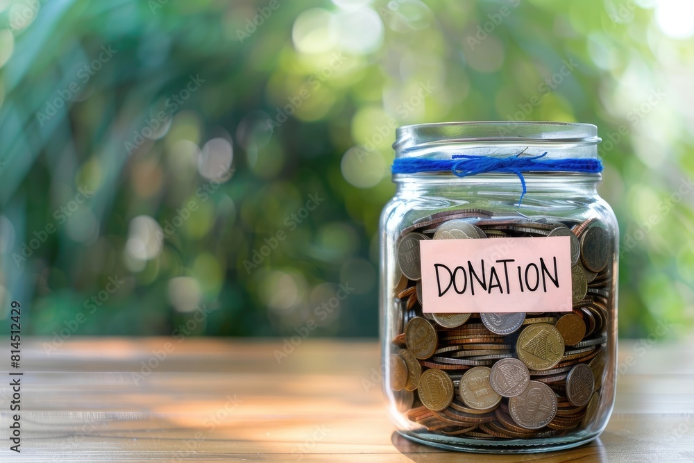 Donation Jar Filled with Coins on Wooden Table Donation Jar Filled with Coins on Wooden Table