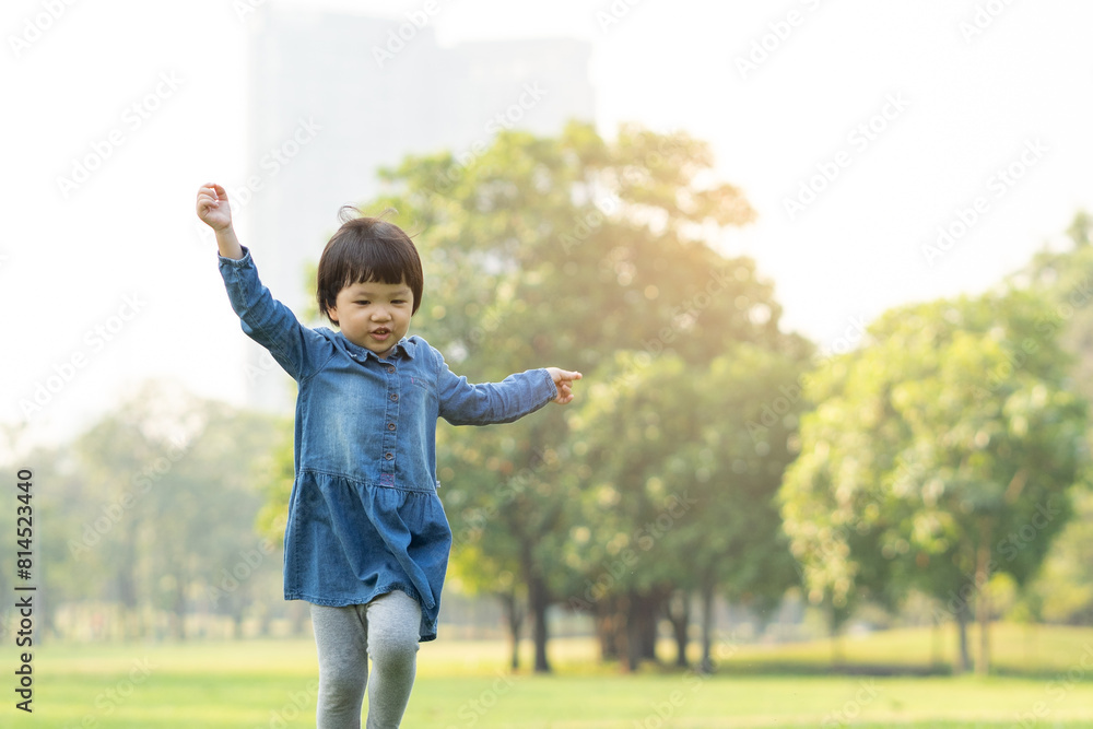 Asian little girl enjoy playing in par Asian little girl enjoy playing in par