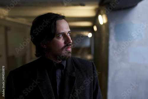 a serious man in a black coat on the street in Krasnoyarsk © madnessbrains