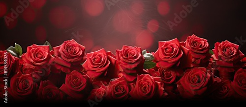 Fototapeta Naklejka Na Ścianę i Meble -  A stunning backdrop showcasing a vibrant arrangement of red roses with ample space for copy and image