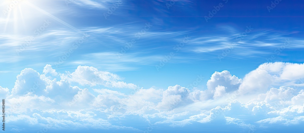 Sunny blue skies peek through wispy clouds in a captivating image offering ample copy space for a versatile and abstract background Sunny blue skies peek through wispy clouds in a captivating image offering ample copy space for a versatile and abstract background