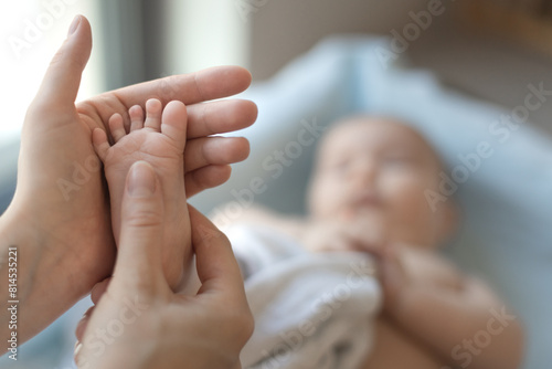 doctor examining a baby, checking the reflexes of the newborn,