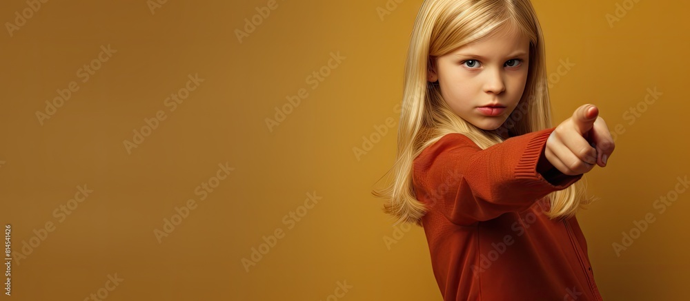 Isolated image of a youthful girl confidently pointing her finger towards the copy space Isolated image of a youthful girl confidently pointing her finger towards the copy space