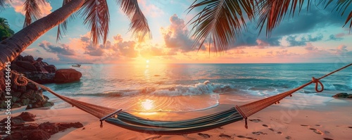 Peaceful hammock set between towering palms on a pristine beach, facing sparkling waters under a sky in sunrise photo
