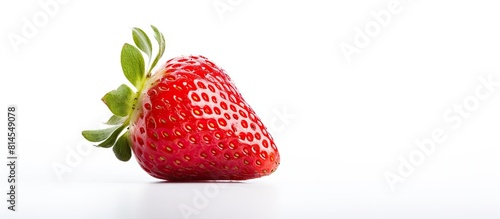 An organic fresh strawberry is showcased on a white background providing an ideal copy space for recipes or culinary articles