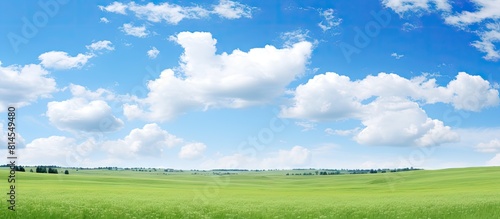 A peaceful summer scene with a clear blue sky adorned by fluffy white clouds offering plenty of space for text or images. with copy space image. Place for adding text or design