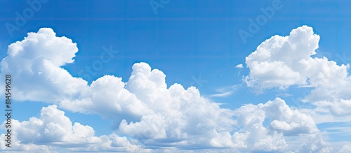 A copy space image depicts billowy white clouds against a tranquil blue sky