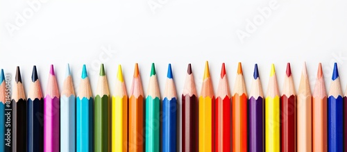 A vibrant assortment of colored pencils set against a pristine white backdrop ideal for adding creativity and style to any design image with copy space