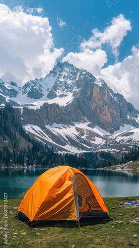 A tent pitched on the steep side of a mountain, overlooking the stunning landscape below