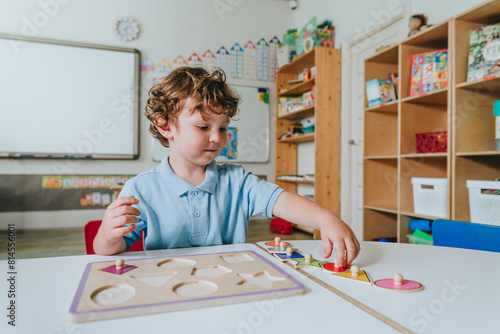 Boy playing with educational wooden toys in a kindergarten