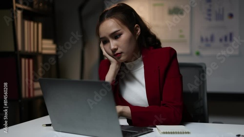 Serious business woman is stressed and bored with too much paperwork to miss the deadline. She is working tiring overtime. Overworked woman is stressed over unfinished paperwork. photo