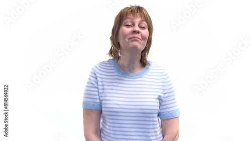 A young woman displays arrogance by arrogantly turning her nose up and looking down haughtily. White background. photo