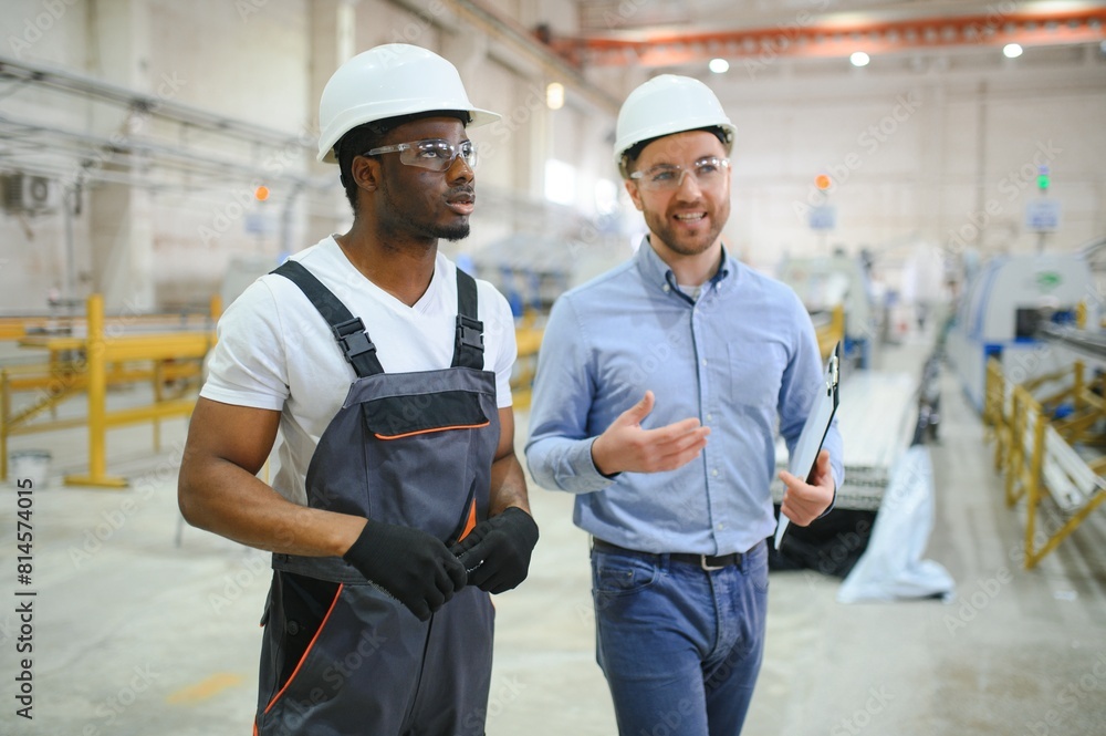 Two workers at the factory. Engineer and worker Two workers at the factory. Engineer and worker