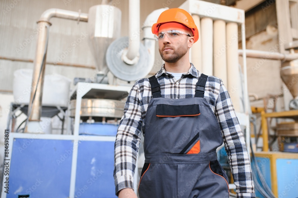 Portrait of factory worker. Young handsome factory worker
