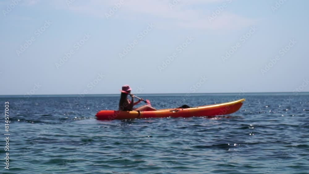 Woman sea kayak. Happy smiling woman paddling in kayak on ocean. Calm sea water and horizon in background. Active lifestyle at sea. Summer vacation. Woman sea kayak. Happy smiling woman paddling in kayak on ocean. Calm sea water and horizon in background. Active lifestyle at sea. Summer vacation.