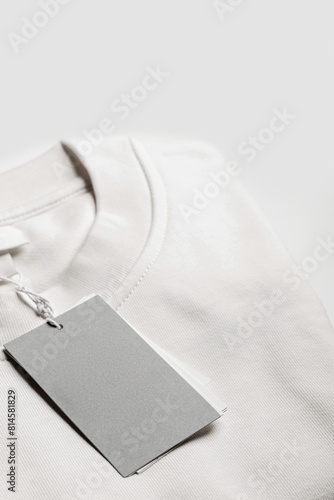 Close-up of a blank tag on white clothing. Resource for mockup design.