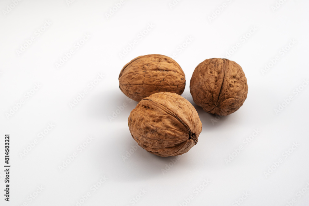 Walnuts on a white background. Close-up. Unpeeled walnuts. Healthy nutrition. Natural vitamins. A source of fiber. Natural food Walnuts on a white background. Close-up. Unpeeled walnuts. Healthy nutrition. Natural vitamins. A source of fiber. Natural food